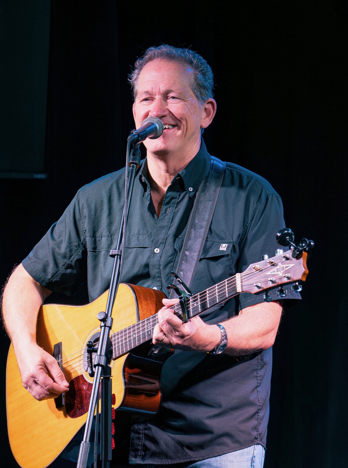 Ray Fogg on stage at Reel Bar with guitar