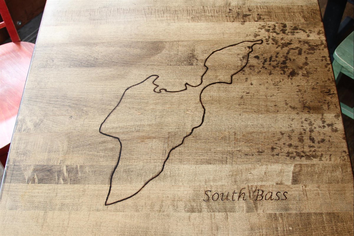 South Bass Island map etched into a wooden table at Reel Bar