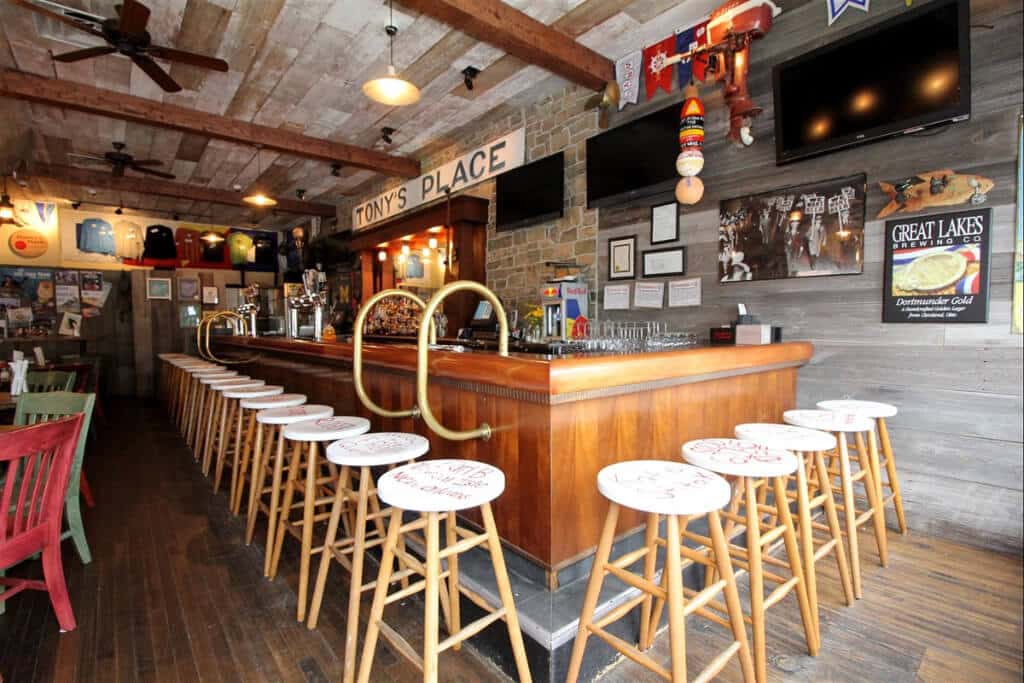 Reel Bar interior — wooden bar, stools, and island décor